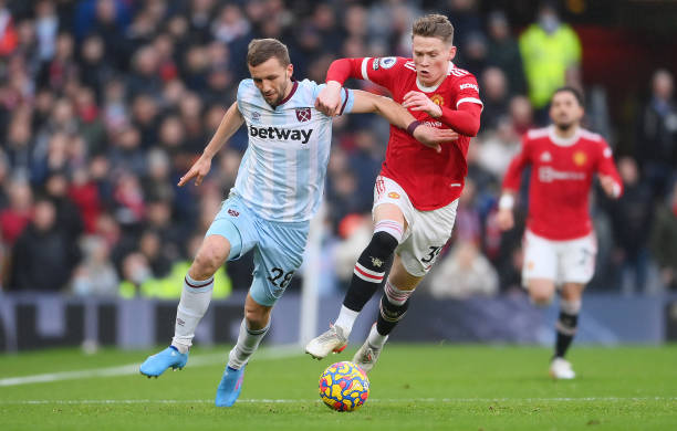 Tomas Soucek of West Ham United is challenged by Scott McTominay of Manchester United during the Premier League match between Manchester United and...