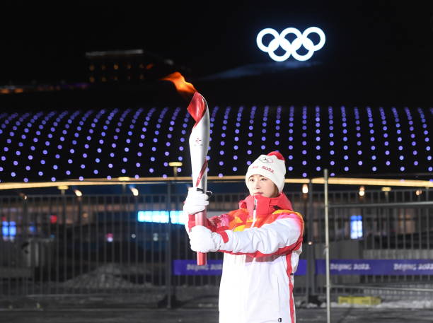 Torch bearer Wang Wenzhuo prepares to light up the cauldron of Zhangjiakou competition area after the opening ceremony of the Beijing 2022 Winter...