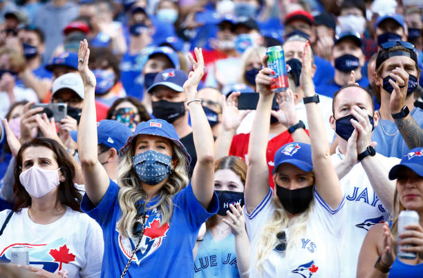 Toronto Blue Jays fans cheer as the team makes their way onto the field for their first home game in Toronto this season prior to a MLB game against...