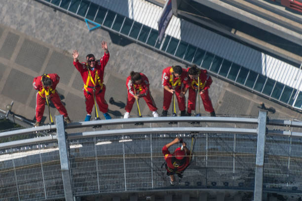 tourists-doing-the-edgewalk-in-the-cn-tower-it-is-the-worlds-highest-picture-id853641496