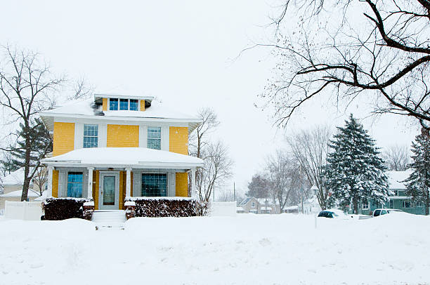 traditional home in a snow storm picture