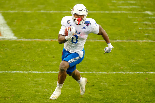 Tulsa Golden Hurricane running back Deneric Prince runs through the line of scrimmage during the Armed Forces Bowl game between the Tulsa Golden...