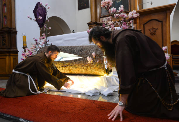 Two monks from the Order of Friars Minor Capuchins prepare the tomb of Christ inside the Cloister Church in Krakow. On Thursday, April 9 in Krakow,...