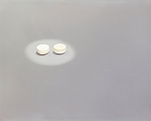 Two pills on white background
