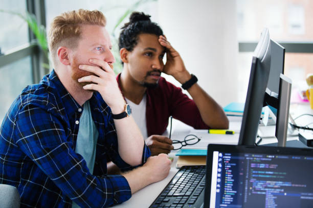 two programmers working together on a computer code. - software development stock pictures, royalty-free photos & images