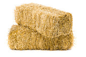 Two stacked bales of hay on white background