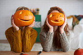 Two women showing halloween pumpkins