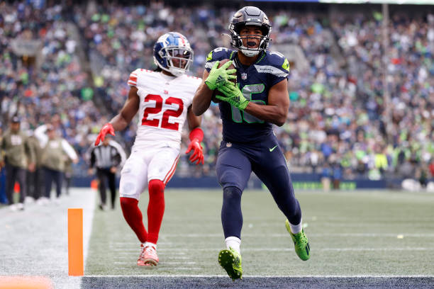 Tyler Lockett of the Seattle Seahawks scores a touchdown during the fourth quarter against the New York Giants at Lumen Field on October 30, 2022 in...