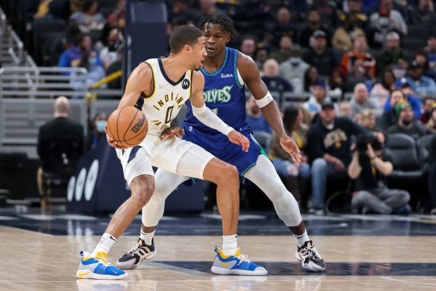 Tyrese Haliburton of the Indiana Pacers dribbles the ball while being guarded by Anthony Edwards of the Minnesota Timberwolves in the second quarter...