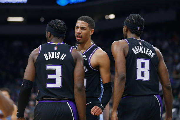 Tyrese Haliburton of the Sacramento Kings celebrates with teammates Terence Davis and Maurice Harkless after a play in the second quarter against the...