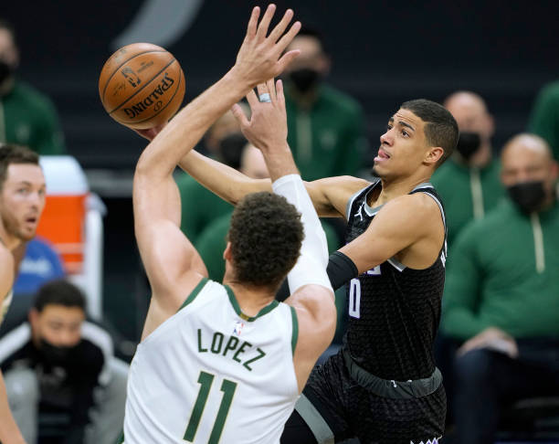 Tyrese Haliburton of the Sacramento Kings shoots against Brook Lopez of the Milwaukee Bucks during the first half of an NBA basketball game at Golden...