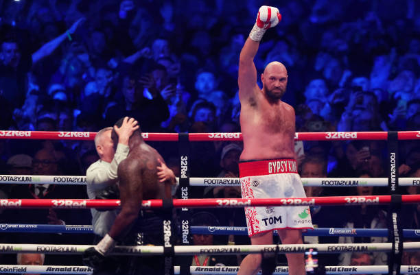 Tyson Fury celebrates victory as referee Mark Lyson checks on Dillian Whyte after the WBC World Heavyweight Title Fight between Tyson Fury and...