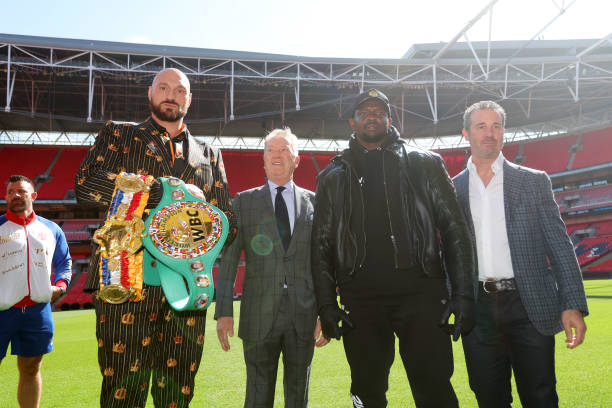 Tyson Fury, promoter Frank Warren, Dillian Whyte and Todd DuBoef, President of Top Rank Boxing pose for a photo during a press conference ahead of...