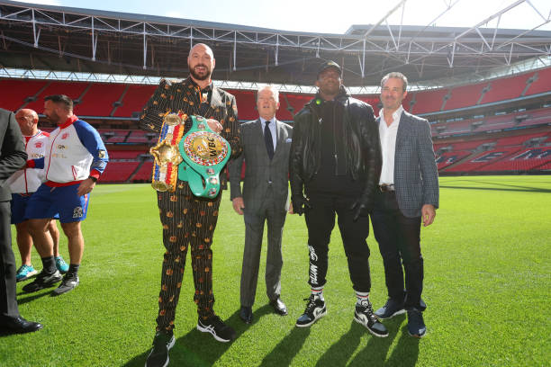 Tyson Fury, promoter Frank Warren, Dillian Whyte and Todd DuBoef, President of Top Rank Boxing pose for a photo during a press conference ahead of...
