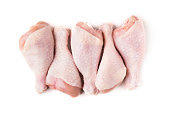 Uncooked chicken legs on white background