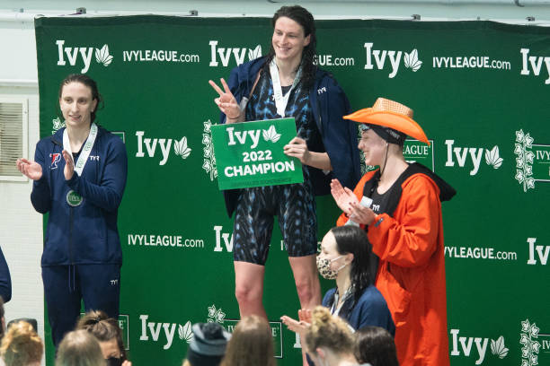 University of Pennsylvania swimmer Lia Thomas smiles on the podium after winning the 500 freestyle during the 2022 Ivy League Womens Swimming and...