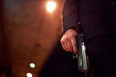 Unrecognizable person holding a handgun at night