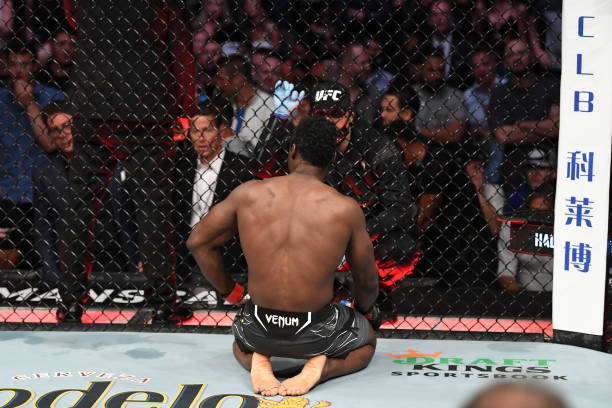 Uriah Hall of Jamaica talks to his coaches after facing Chris Weidman in their middleweight bout during the UFC 261 event at VyStar Veterans Memorial...