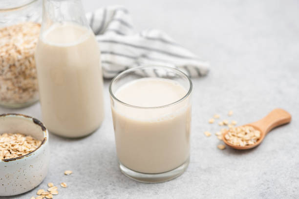 vegan oat milk in glass - oat milk ストックフォトと画像