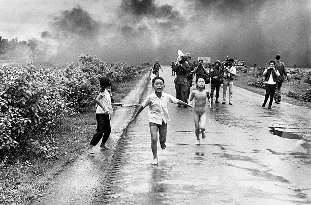Vietnamese children flee from their homes in the South Vietnamese village of Trang Bang after South Vietnamese planes accidently dropped a napalm...