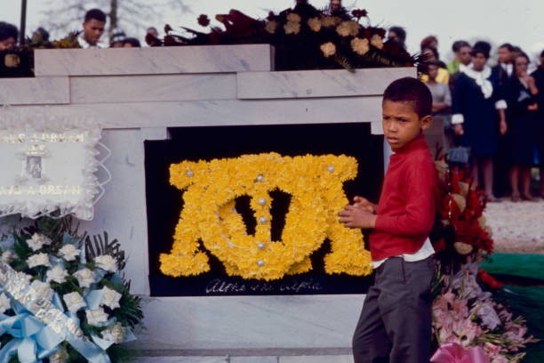 View of an unidentified young boy as he stands in front of Dr Martin Luther King Jr's headstone, Atlanta, Georgia, April 9, 1968.