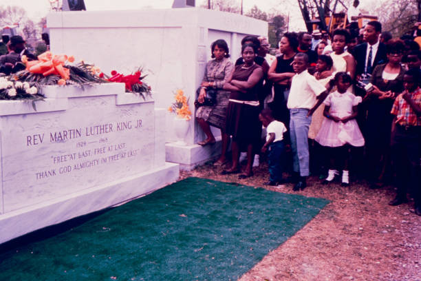 View of mourners as they stand beside Dr Martin Luther King Jr's headstone during his burial service, Atlanta, Georgia, April 9, 1968.