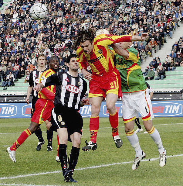 Vincenzo Iaquinta of Udinese is beaten to a header by Lorenzo Stovini of Lecce in action during the Serie A match between Udinese and Lecce on March...