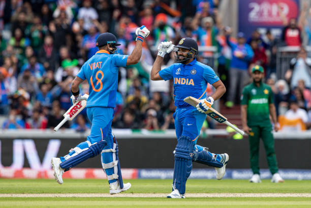 Virat Kohli of India punches the air as team mate Rohit Sharma reaches his century during the Group Stage match of the ICC Cricket World Cup 2019...
