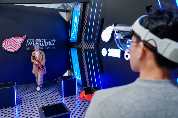 Visitors play a video game with headsets during 2019 NetEase Future Conference at Hangzhou International Expo Center on November 23, 2019 in...