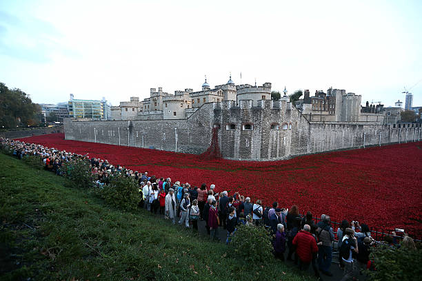 Visitors view the 'Blood Swept Lands and Seas of Red' installation at Tower of London on October 30 2014 in London England The installation by...