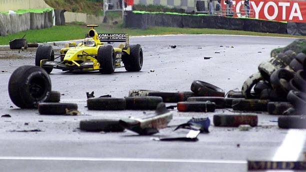Giancarlo Fisichella makes his way through debris on the circuit