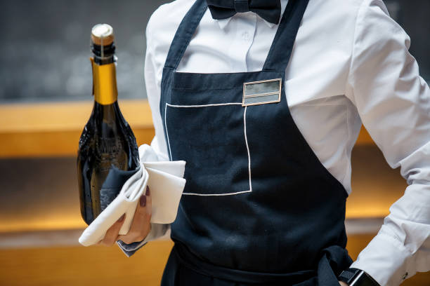 waiter in a restaurant with a bottle of prosecco picture