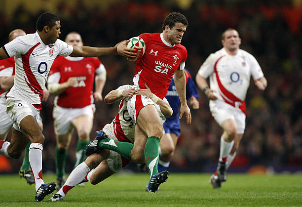 Wales' centre Jamie Roberts tries to break tackles from England scrum half Harry Ellis and Delon Armitage during the Six Nations rugby match at the...