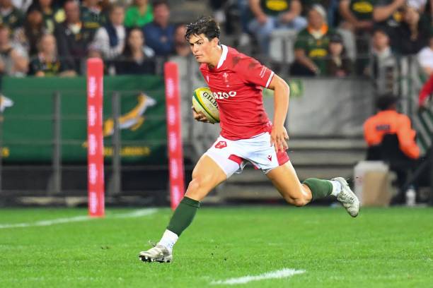 Wales' wing Louis Rees-Zammit runs with the ball during an international rugby union match between South Africa and Wales at the Cape Town Stadium in Cape Town on July 16, 2022. (Photo by RODGER BOSCH / AFP) (Photo by RODGER BOSCH/AFP via Getty Images)