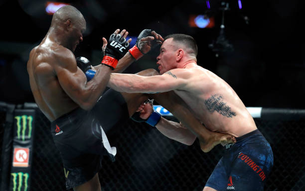 Welterweight champion Kamaru Usman kicks Colby Covington in their welterweight title fight during UFC 245 at T-Mobile Arena on December 14, 2019 in...