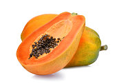 whole and half of ripe papaya fruit with seeds isolated on white background