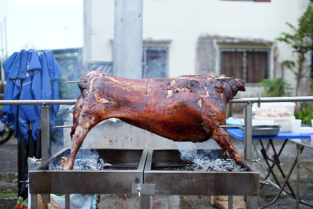 whole lamb on skewer grilled to perfection using hot charcoal picture