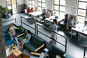 Wide Angle View of a Modern Loft Open Space Office With Businesspeople Working in It