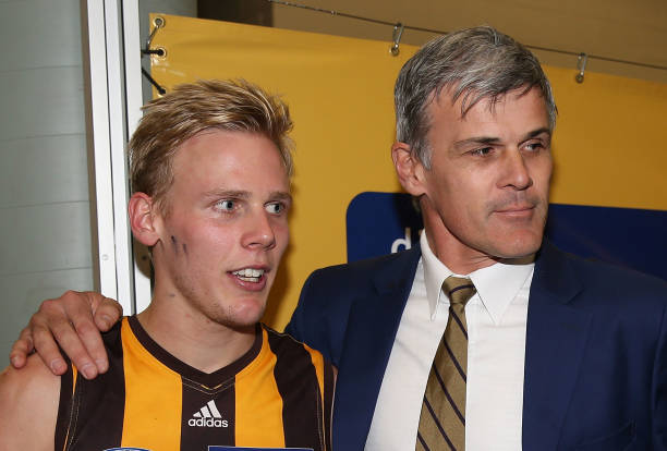 Will Langford of the Hawks celebrates the win after his first game with dad Chris Langford after the round 17 AFL match between the Hawthorn Hawks...