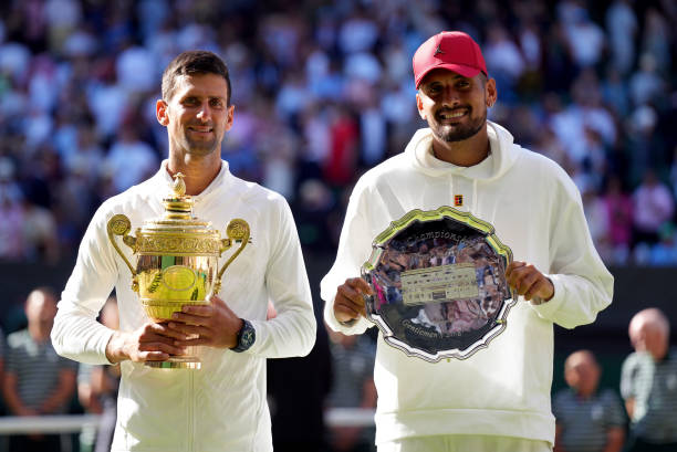 Wimbledon Champion Novak Djokovic with his trophy alongside runner up Nick Kyrgios following The Final of the Gentlemen's Singles on day fourteen of...