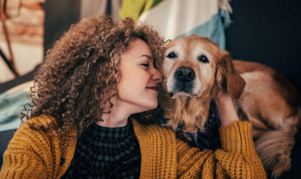 woman cuddling with her dog - beautiful dog stock pictures, royalty-free photos & images