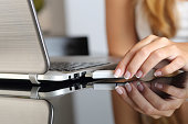 Woman hand plugging a pendrive on a laptop at home