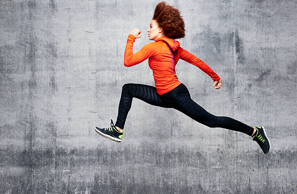woman jumping in air in urban studio picture