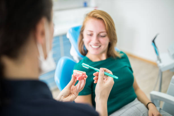 woman patient listening to denture cleaning advice