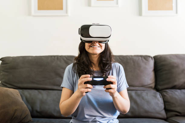 woman playing a video game with a controller and vr glasses at home picture id1307593189?k=20&m=1307593189&s=612x612&w=0&h=HfA