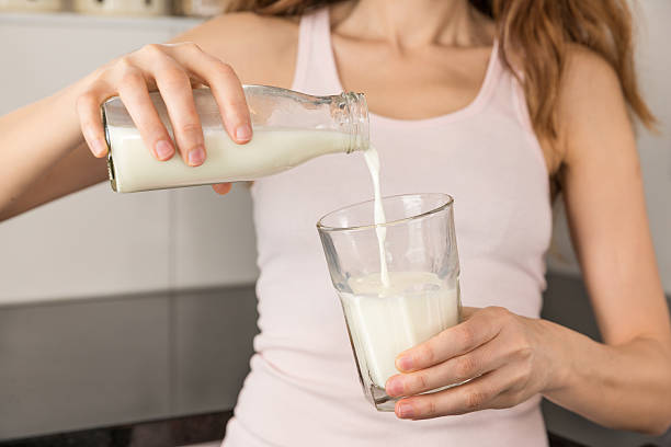 Woman pouring milk from a bottle