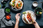 Woman preparing tasty vegan tacos