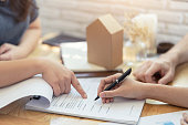 woman putting signature on document contract, real estate purchase, success business contract deals with sale represent.