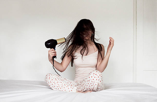woman sitting on bed blow drying hair picture id143462844?k=20&m=143462844&s=612x612&w=0&h=WVd2EzcBnK9D43D6xFbNYmGvdJVKvaJ 19yK rrdSMY=
