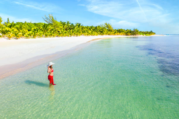 Woman standing in the caribbean sea, Playa del Carmen, Mexico